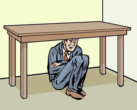 man-hiding-under-table-csa-images